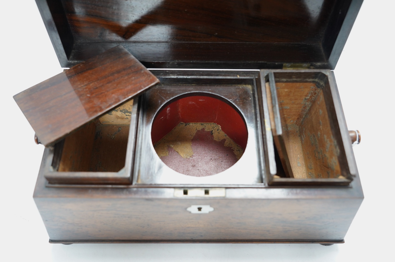 A Victorian rosewood sarcophagus shaped tea caddy with mother of pearl escutcheon, 33.5cm wide. Condition - fair, some internal damage